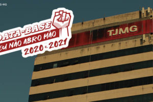 Vista da sede do Tribunal de Justiça de Minas Gerais na Avenida Afonso Pena, à frente desta imagem está a aplicação digital do selo "Data-Base 2020 e 2021 - Eu não abro mão". Conteúdo textual: CONQUISTA - Datas-Bases 2020 e 2021 são sancionadas e viram Lei 24.037/2022.