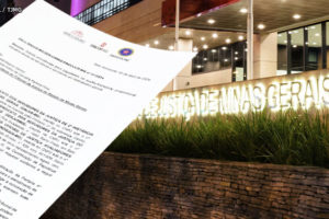 Foto noturna da Sede do Tribunal de Justiça de Minas Gerais com o letreiro iluminado, sobre esta imagem há a aplicação digital de uma folha de papel com um ofício.
