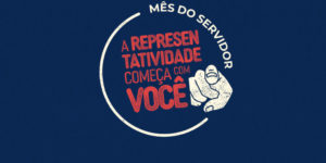 Imagem Acessível: Fundo azul-escuro, com composição gráfica em vermelho e branco com a frase "Mês do Servidor - A representatividade começa com você”, acompanhada de uma ilustração de um dedo apontando para a frente. Conteúdo textual: Valorização - SINJUS promove campanha e sorteio especial em celebração ao Mês do Servidor.