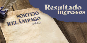 A imagem anuncia o resultado do sorteio relâmpago de ingressos promovido pelo SINJUS-MG para o sarau com o título provocativo: “A tirania do gozo imediato x A última dor que me salvou”. O fundo simula uma mesa de madeira rústica com uma folha de papel antigo e uma pena mergulhada em tinteiro, remetendo à escrita poética. A tipografia elegante e o contraste de cores entre o papel envelhecido e o azul profundo destacam o caráter artístico e cultural do evento. A identidade visual remete à tradição literária e convida o público a conferir as contempladas pelo sorteio