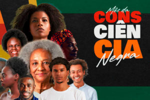 montagem com fundo nas cores ligadas à cultura afro (verde, laranja, vermelho, laranja e azul) com diversos rostos de pessoas negras e o seguinte conteúdo textual: Mês da Consciência Negra.