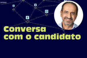 Representação de redes sociais e aplicativos interconectados, abaixo desta imagem há o texto "Conversa com o candidato". Em destaque está a foto do candidato Alexandre Kalil, um homem branco sorridente, ele tem cabelos grisalhos, é calvo e usa barba cerrada também grisalha.