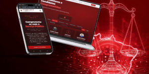 Card sobre a Plataforma Política da FENAJUD. Em fundo vermelho e preto, um celular exibe uma tela com a chamada “Comprometa-se com o Serviço Público”, enquanto um notebook mostra a página “Parlamentares e Candidatos Comprometidos”, com nomes de signatários. Ao fundo, aparece uma ilustração da balança da Justiça em contornos neon e elementos que remetem à tecnologia.